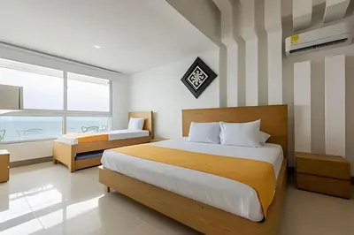 a bedroom with a large bed and a window at Lujoso Apto de 3 Habitaciones-3303 Palmetto Beach in Cartagena de Indias