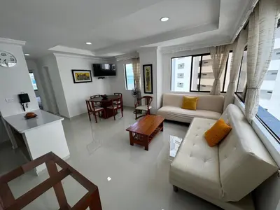 a living room with a couch and a table at Apartamento en Bocagrande con vista lateral al mar ICDI in Cartagena de Indias