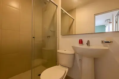a bathroom with a toilet and a sink and a mirror at Casa Hibiscus - Joya en Getsemani in Cartagena de Indias