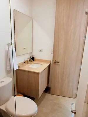 a bathroom with a sink and a toilet and a mirror at Apartamento con vista al mar in Simón Bolivar