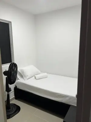 a white room with a bed and a fan at Rent by days, 4th floor apartment in Cartagena de Indias
