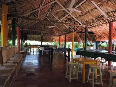 a bar with tables and stools in a building at Casafinca en Arjona # 3 in Cartagena de Indias