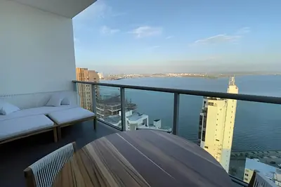a balcony of a building with a view of the water at Infinitum Spectacular 23rd floor 1 BR Condo in Cartagena de Indias