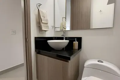 a bathroom with a white bowl sink on a counter at Infinitum Spectacular 23rd floor 1 BR Condo in Cartagena de Indias