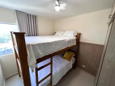 a bedroom with two bunk beds and a ceiling fan at Team Renacer Broker Brisas del Mar and Pool in Cartagena de Indias
