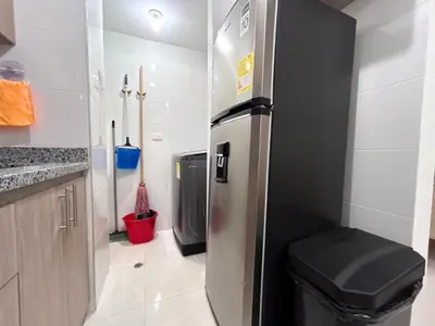a kitchen with a stainless steel refrigerator with a trash can at Team Renacer Broker Brisas del Mar and Pool in Cartagena de Indias