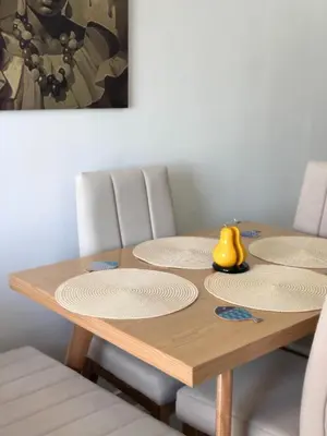 a wooden table with four chairs and a yellow duck on it at Team Renacer Broker Brisas del Mar and Pool in Cartagena de Indias
