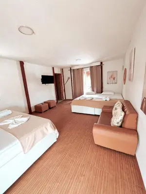 a large room with two beds and a couch at Margarita's Beach Club in Playa Punta Arena