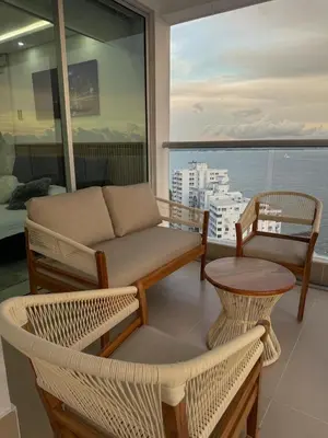 a living room with a couch and chairs and a window at Apartamento en Palmetto sunset frente al mar piso 20 in Cartagena de Indias