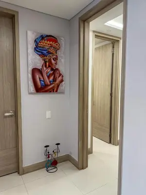 a painting of a woman on a wall in a hallway at Apartamento en Palmetto sunset frente al mar piso 20 in Cartagena de Indias