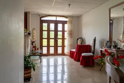 a living room with a red table and chairs at Donde Mire in Puerto Colombia