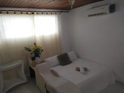 a bedroom with a bed with two shoes on it at Apartamento en Manga cerca al Centro Historico in Cartagena de Indias