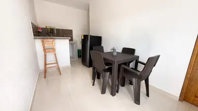 a dining room with a black table and chairs at Cabaña Datalu 2 in Coveñas