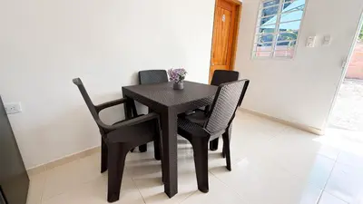 a black table and chairs in a room at Cabaña Datalu 2 in Coveñas