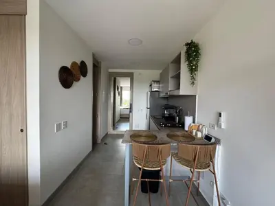 a kitchen with a counter and stools in a room at Apartamento cerca al mar santa Marta- santamarina-614 in Santa Marta