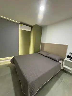 a bedroom with a large bed in a room at Coral Tower in Barranquilla