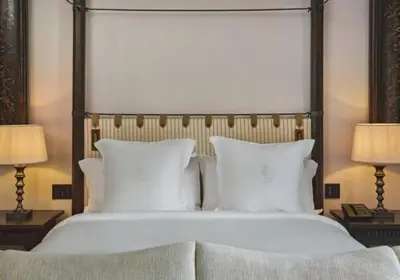 a bedroom with a large white bed with two lamps at Four Seasons Hotel & Residences Cartagena in Cartagena de Indias