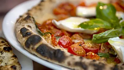 two plates of pizza with vegetables on them at Four Seasons Hotel & Residences Cartagena in Cartagena de Indias