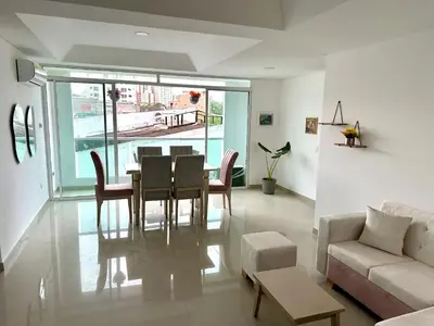 a living room with a table and chairs and a couch at Dubai 202 in Barranquilla