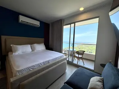 a bedroom with a bed and a view of the ocean at Apartamento de Lujo en Santa Marta con vista al mar -Santamarina- 1802 in Santa Marta