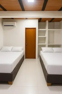 a room with two beds and a door in it at Casa Mariana Hostel Boutique in Santa Marta
