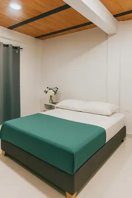 a bedroom with a bed in a white room at Casa Mariana Hostel Boutique in Santa Marta