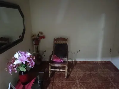 a room with a chair and a mirror and flowers at Apto country in Cartagena de Indias