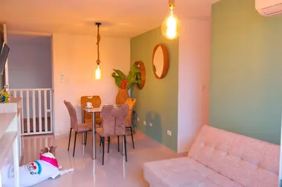 a living room with a couch and a table and chairs at Apartamento primer piso Olamar Coveñas in Coveñas