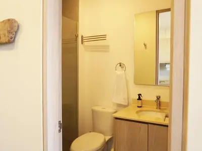 a bathroom with a toilet and a sink and a mirror at Santa Marta apartamento frente al mar -Santamarina- 1202 in Santa Marta