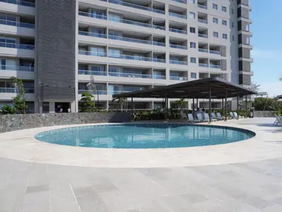 a swimming pool in front of a large building at Santa Marta apartamento frente al mar -Santamarina- 1202 in Santa Marta