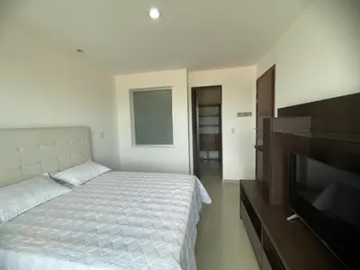a bedroom with a bed and a flat screen tv at Bijao 6b in Barranquilla