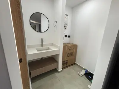 a bathroom with a sink and a mirror at Coral Tower 603 in Barranquilla
