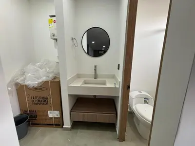 a bathroom with a sink and a mirror and a box at Coral Tower 603 in Barranquilla
