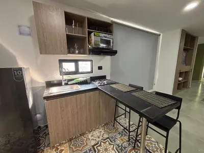 a kitchen with a counter with a sink and a stove at Coral Tower 603 in Barranquilla