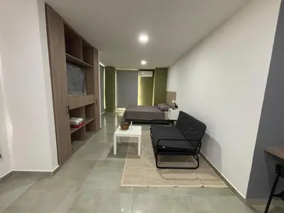 a room with a bed and a chair and a table at Coral Tower 603 in Barranquilla