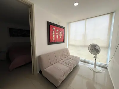 a living room with a couch and a fan at Kairos 1209 in Barranquilla