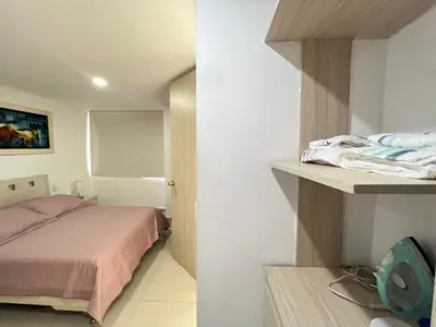 a bedroom with a bed and a room with a mirror at Kairos 1209 in Barranquilla