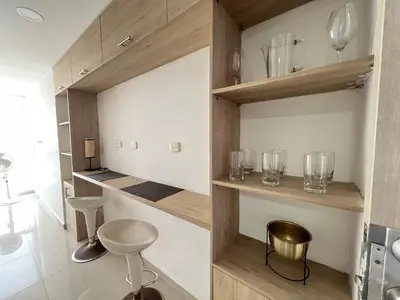 a room with wooden shelves with glasses on them at Kairos 1209 in Barranquilla