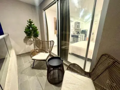 a room with a couch and a chair and a bedroom at Apartamento con vistas al mar-SantaMarina-1303 in Santa Marta
