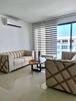 a living room with couches and a table and a large window at Morros Eco in Cartagena de Indias