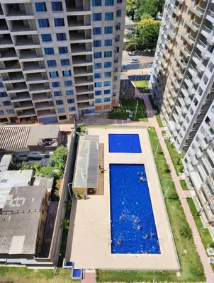 an overhead view of a swimming pool between two tall buildings at Apartamento moderno con una increíble vista en zona exclusiva de la ciudad de Barranquilla in Barranquilla