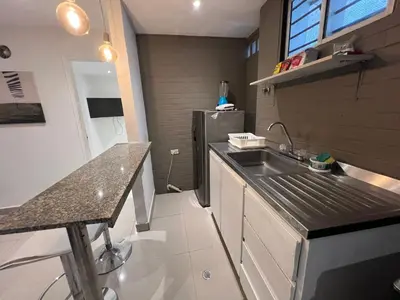 a small kitchen with a sink and a refrigerator at Edificio Quintero in Barranquilla
