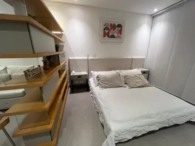 a small bedroom with a bed and shelves at Distrito 90 in Barranquilla