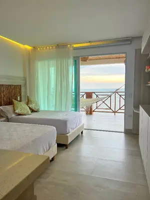 a bedroom with two beds and a view of the ocean at Apartamento frente al mar in San Silvestre