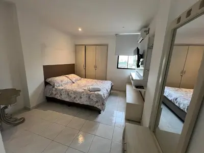 a small bedroom with two beds and a mirror at Vistas del Mar in Barranquilla