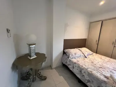 a small bedroom with a bed and a table at Vistas del Mar in Barranquilla