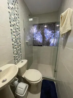 a bathroom with a toilet and a sink and a shower at Apto Amplio con Piscina 3 Hab a Pasos del Mar in Cartagena de Indias