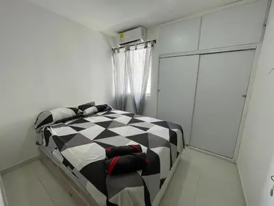 a bedroom with a black and white checkered bed at Apto Amplio con Piscina 3 Hab a Pasos del Mar in Cartagena de Indias