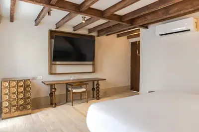a room with a table and a large tv at Hotel Palacio del Agua by Faranda Boutique in Cartagena de Indias