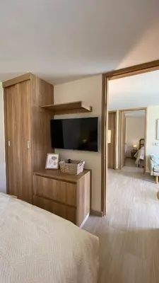 a bedroom with a flat screen tv and a bed at Minimalist and cozy apartment in Barranquilla